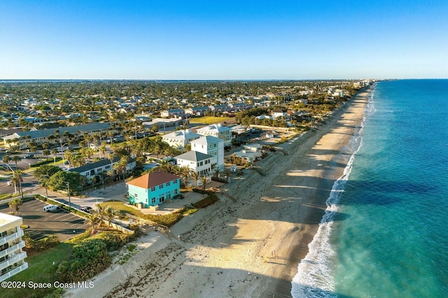 aerial view with a water view and a view of the beach