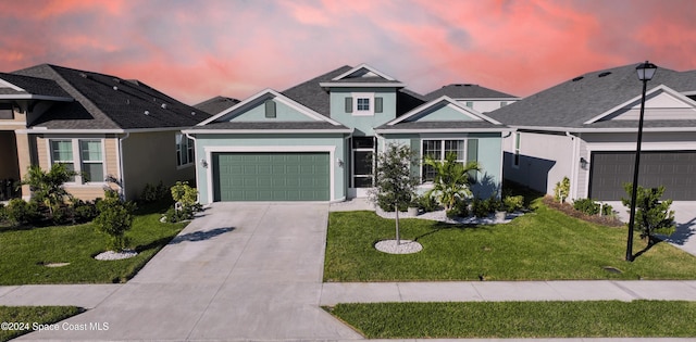 view of front facade with a garage and a yard