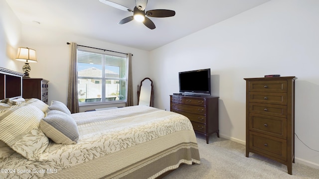 bedroom featuring ceiling fan and light carpet