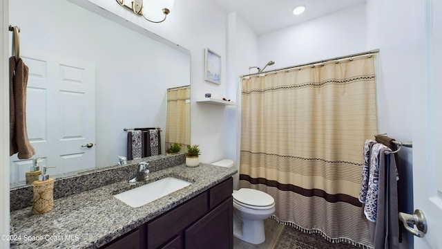 bathroom with toilet, vanity, and curtained shower