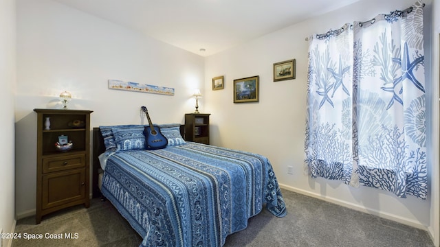 bedroom featuring dark carpet