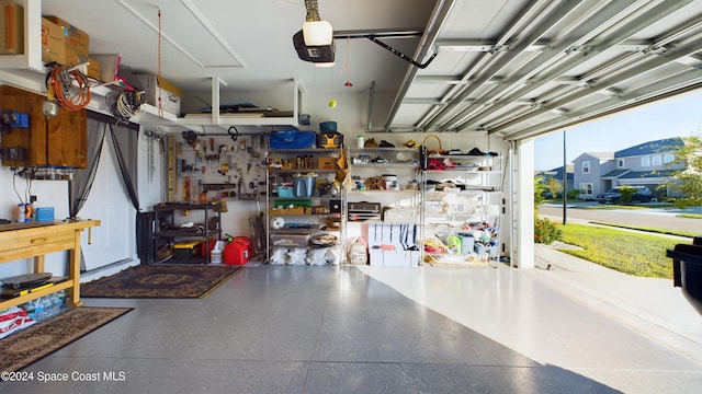 garage with a workshop area and a garage door opener