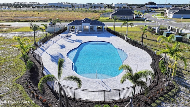 view of pool featuring a patio area and an outbuilding