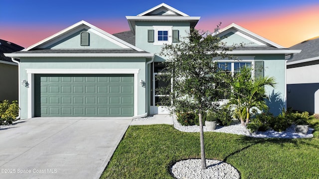 view of front of house with a garage and a lawn