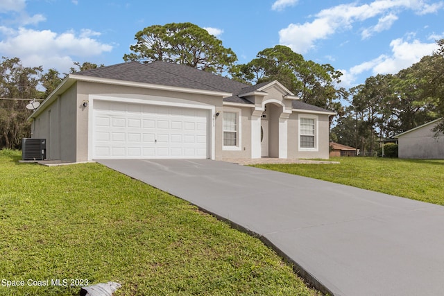 ranch-style house featuring a front lawn, central AC unit, and a garage