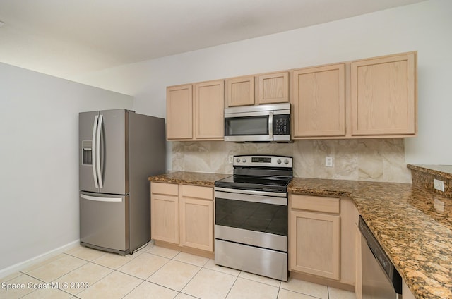 kitchen with tasteful backsplash, light brown cabinets, light tile patterned flooring, and stainless steel appliances