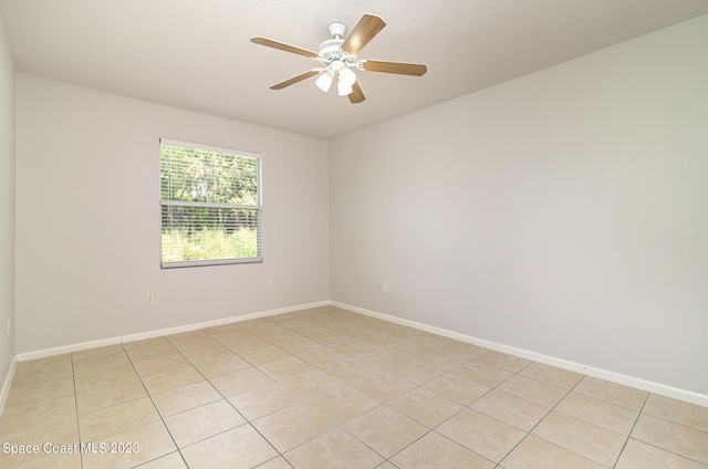 unfurnished room with ceiling fan and light tile patterned floors