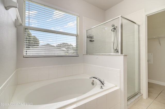 bathroom with tile patterned floors and independent shower and bath