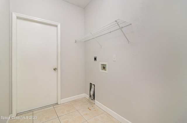 washroom with hookup for an electric dryer, hookup for a washing machine, and light tile patterned flooring