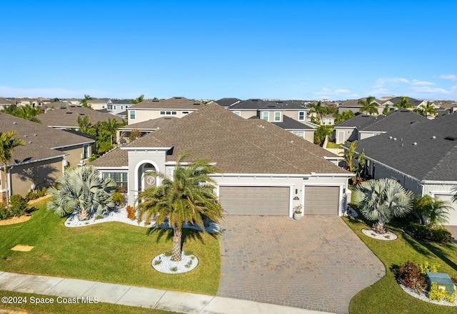 view of front of property featuring a garage and a front lawn