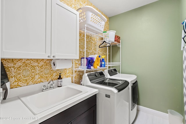 laundry room featuring cabinets, sink, and washing machine and clothes dryer