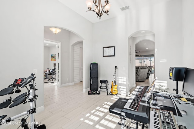 workout area featuring a chandelier