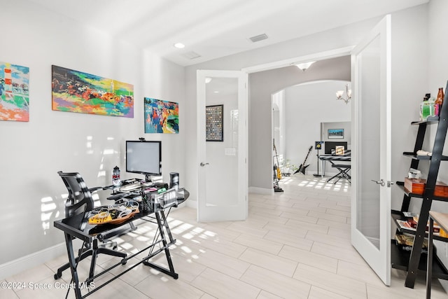 office featuring french doors and a chandelier