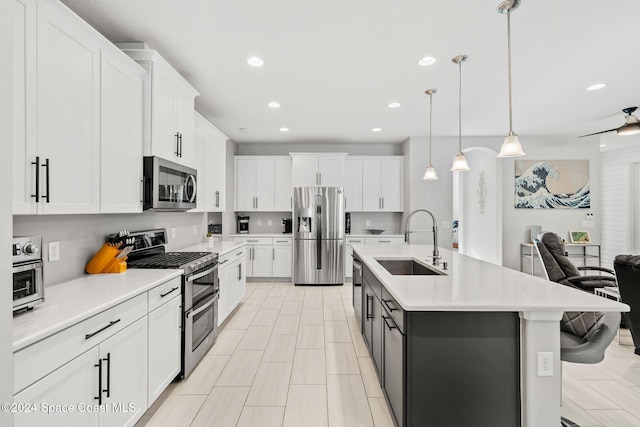 kitchen with sink, white cabinets, and appliances with stainless steel finishes