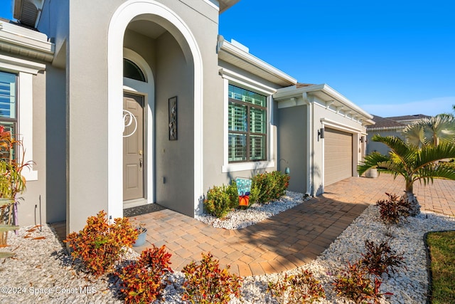 view of exterior entry featuring a garage