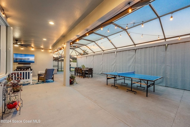 view of patio with glass enclosure