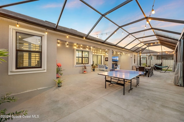 view of patio featuring glass enclosure