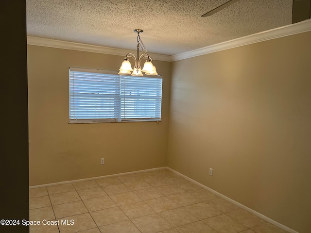 tiled empty room with ornamental molding, a textured ceiling, and a chandelier