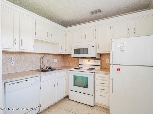 28 Pine Arbor Ln Unit 206, Vero Beach, FL 32962 - kitchen with white appliances, visible vents, a sink, and light countertops