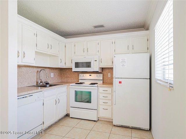 28 Pine Arbor Ln Unit 206, Vero Beach, FL 32962 - kitchen featuring white cabinets, a sink, white appliances, light countertops, and visible vents