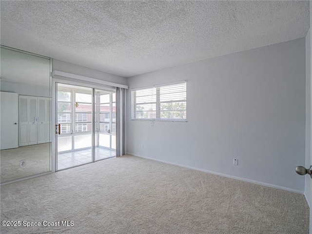 28 Pine Arbor Ln Unit 206, Vero Beach, FL 32962 - carpeted spare room featuring baseboards and a textured ceiling