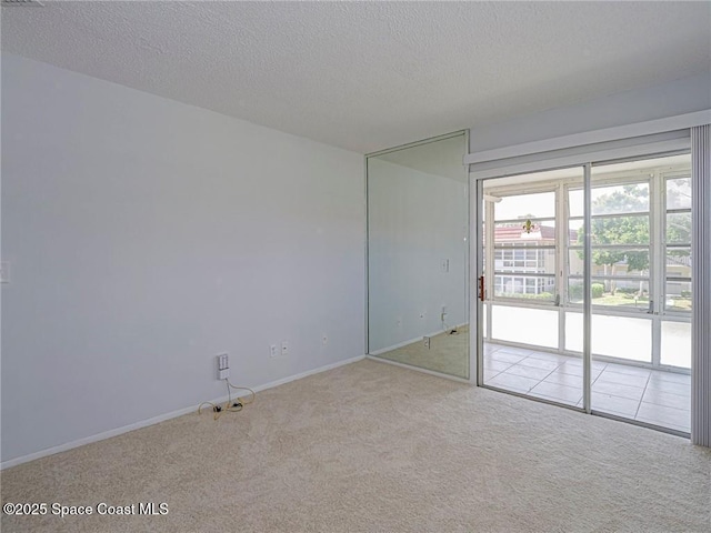 28 Pine Arbor Ln Unit 206, Vero Beach, FL 32962 - empty room featuring baseboards, carpet, and a textured ceiling