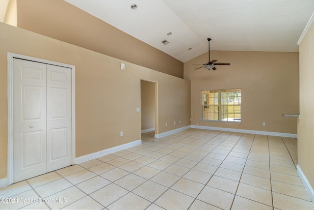 interior space with ceiling fan, light tile patterned floors, and high vaulted ceiling