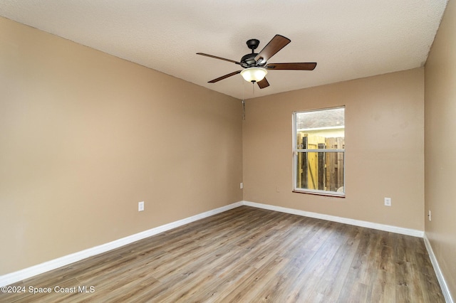 empty room featuring wood-type flooring, a textured ceiling, and ceiling fan