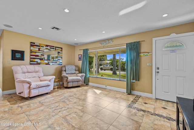 entrance foyer featuring a textured ceiling