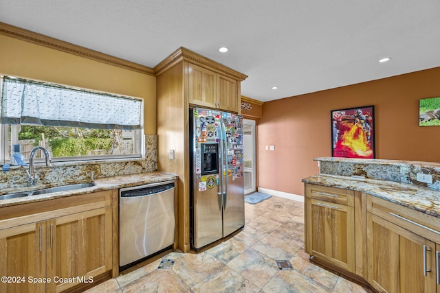 kitchen with light stone counters, sink, ornamental molding, and stainless steel appliances