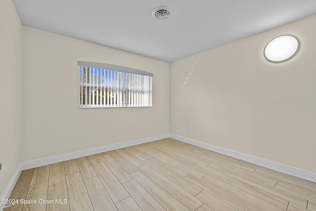 unfurnished room with light hardwood / wood-style floors