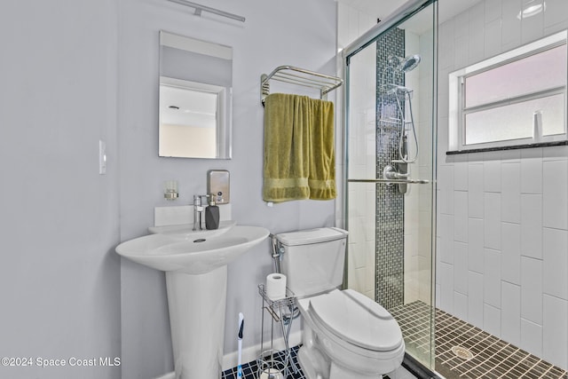 bathroom with a shower with door, tile patterned flooring, and toilet