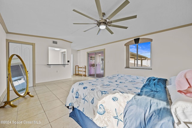 tiled bedroom with ceiling fan, a closet, and crown molding