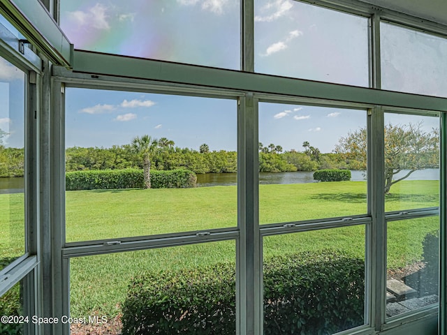 unfurnished sunroom with a water view