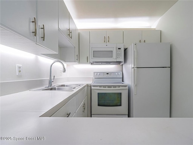 2800 Indian River Blvd Unit L-2, Vero Beach, FL 32960 - kitchen featuring white appliances, a sink, and light countertops