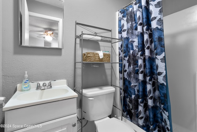 bathroom featuring a shower with curtain, ceiling fan, toilet, and vanity