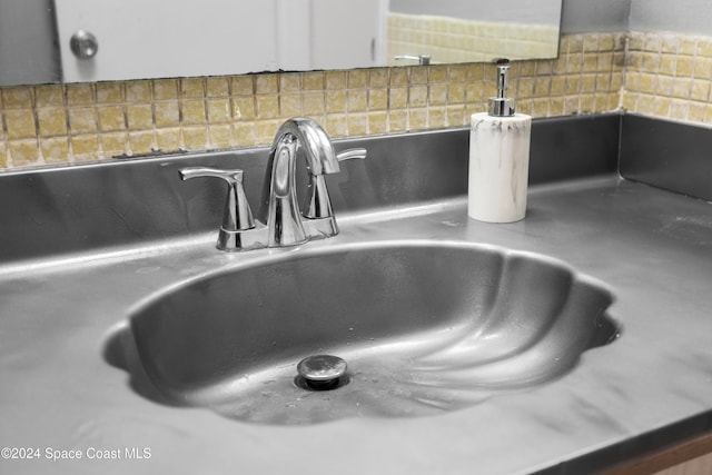 room details featuring backsplash and sink