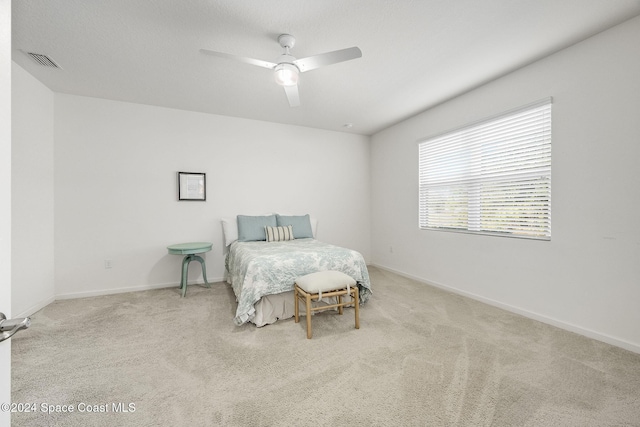 bedroom featuring light carpet and ceiling fan