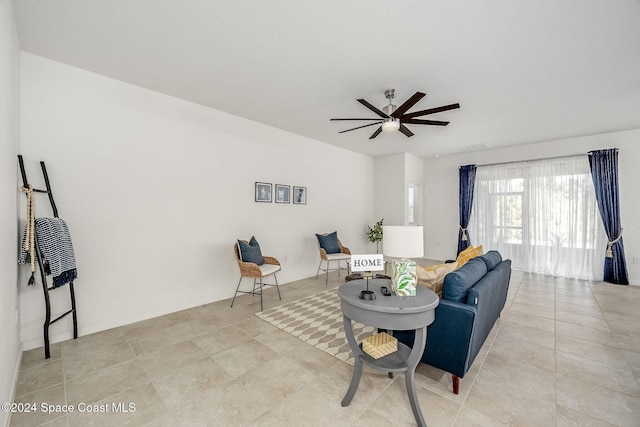 tiled living room with ceiling fan