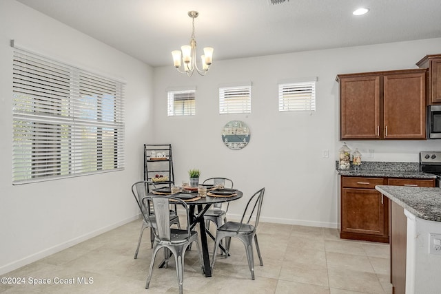 tiled dining space with a notable chandelier