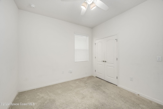 empty room with light carpet and ceiling fan