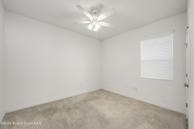 carpeted empty room with ceiling fan