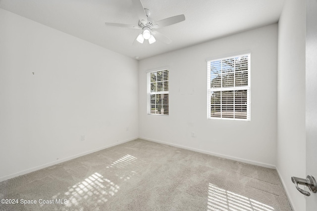 carpeted empty room featuring ceiling fan