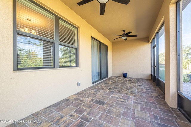 unfurnished sunroom with ceiling fan and a healthy amount of sunlight