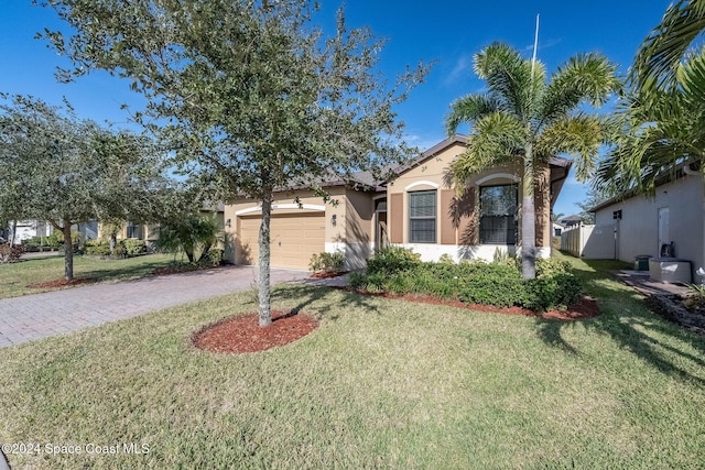 view of front of property with a front lawn and a garage