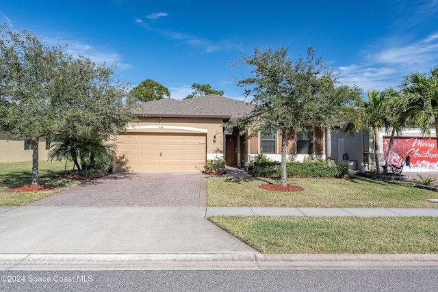 view of front of house with a front yard and a garage