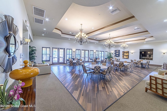 dining room with a raised ceiling, hardwood / wood-style floors, and ornamental molding