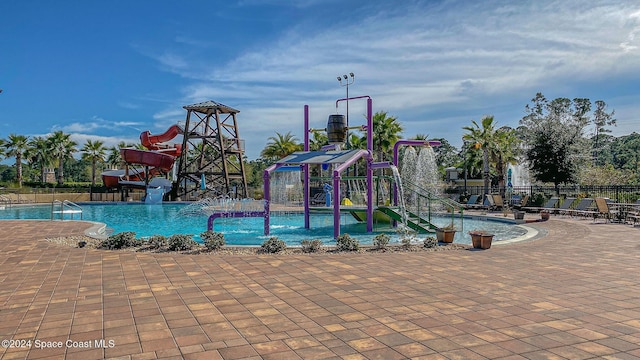 view of swimming pool with a water slide