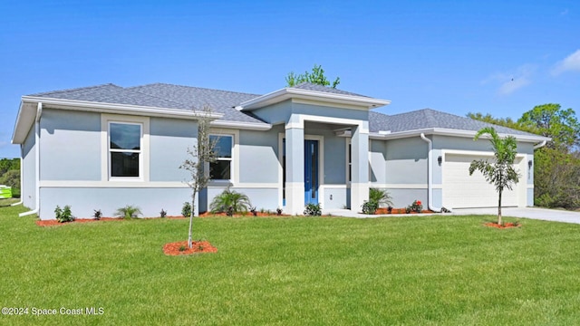 prairie-style house with a garage and a front lawn