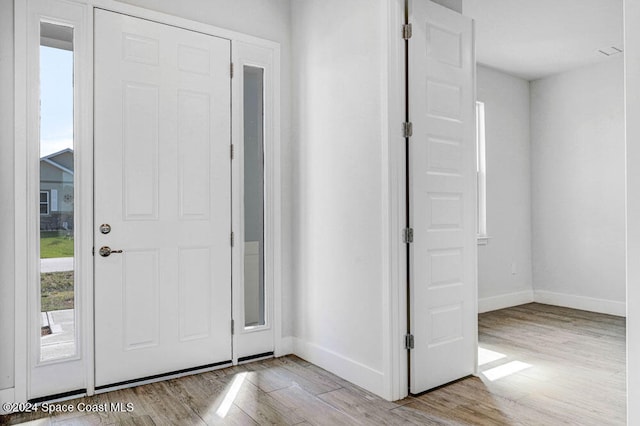 foyer entrance with light hardwood / wood-style floors